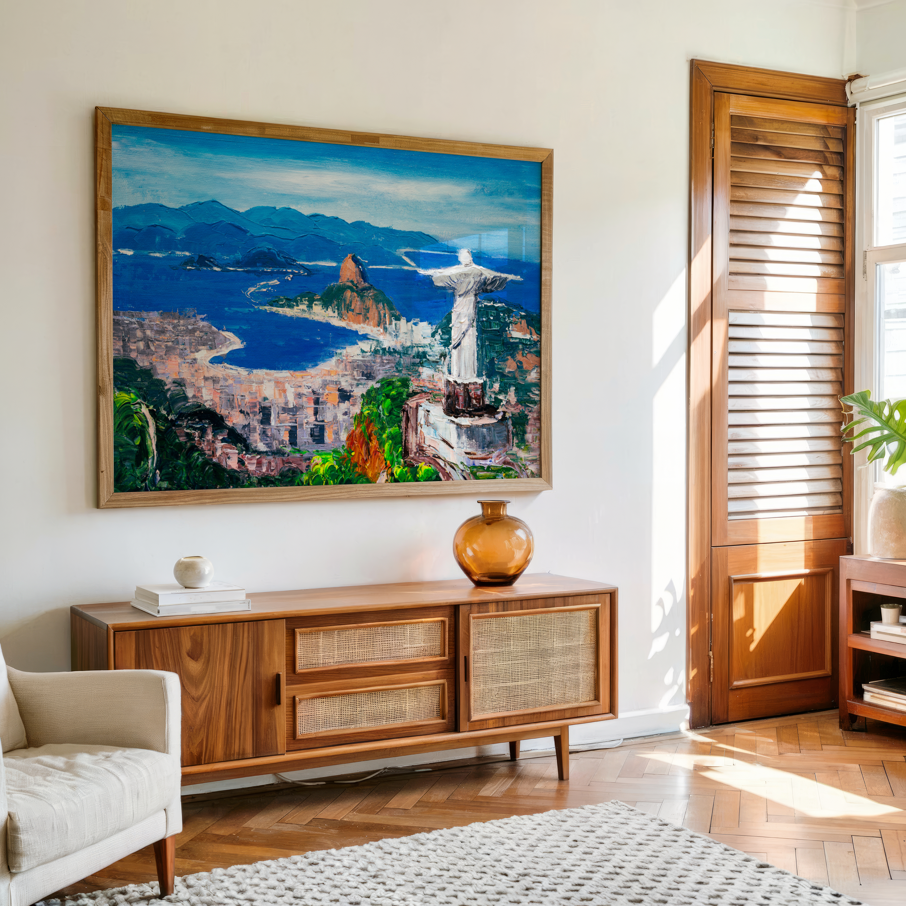 Living room with a large painting of Rio de Janeiro on the wall above a wooden cabinet.