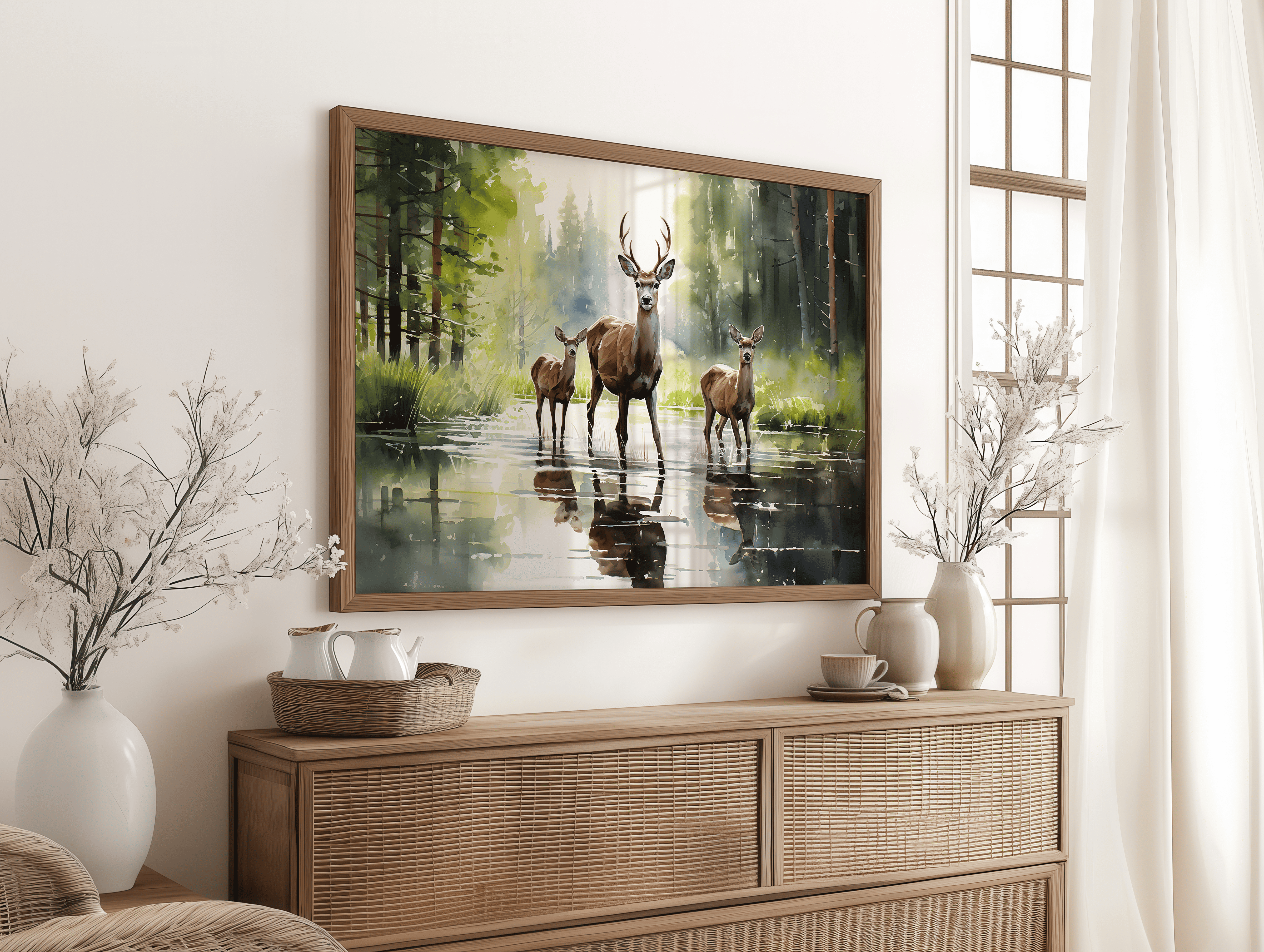 Framed artwork of deer in a forest scene above a wooden console table.